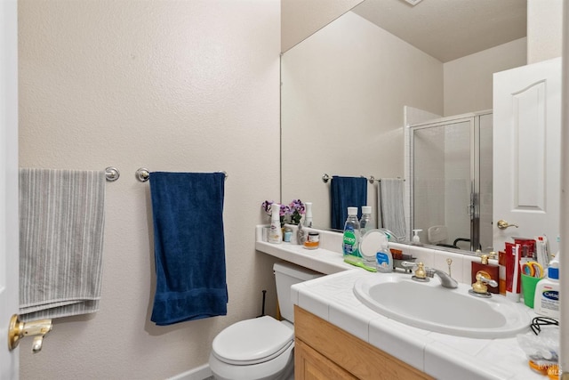 bathroom with vanity, an enclosed shower, and toilet