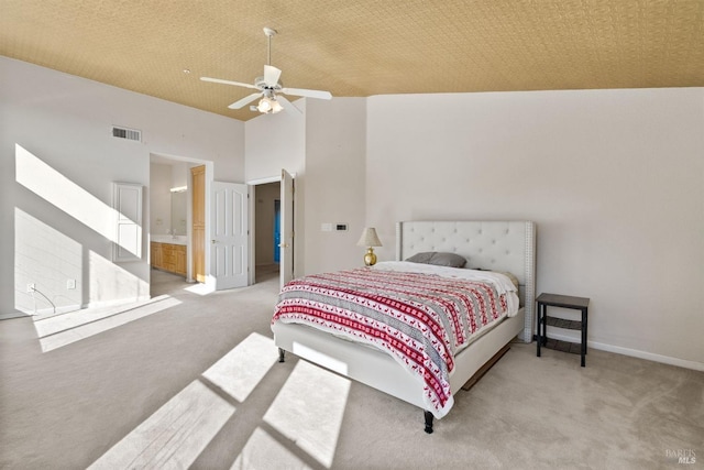 carpeted bedroom featuring connected bathroom, high vaulted ceiling, and ceiling fan