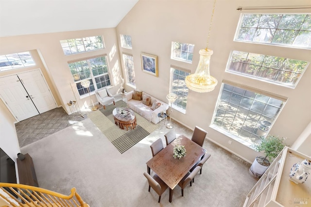 carpeted living room with a healthy amount of sunlight and high vaulted ceiling