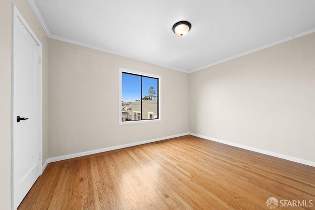 unfurnished bedroom featuring baseboards, wood finished floors, and ornamental molding