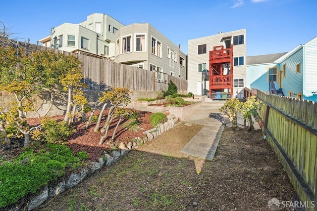 view of home's community with a fenced backyard