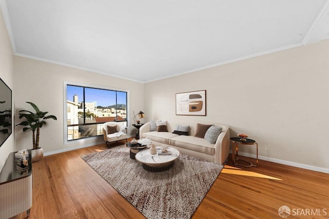 living room featuring ornamental molding, baseboards, and wood finished floors