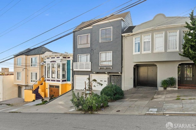 view of property with an attached garage and stucco siding