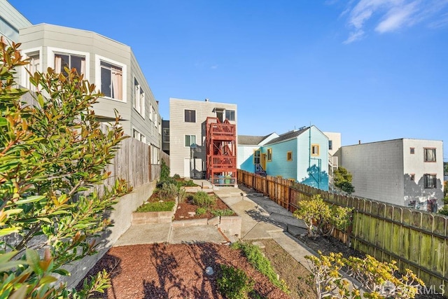 view of community featuring a fenced backyard and a patio