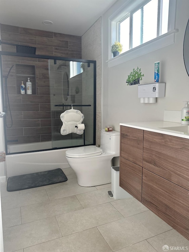 bathroom with vanity, toilet, and tile patterned flooring