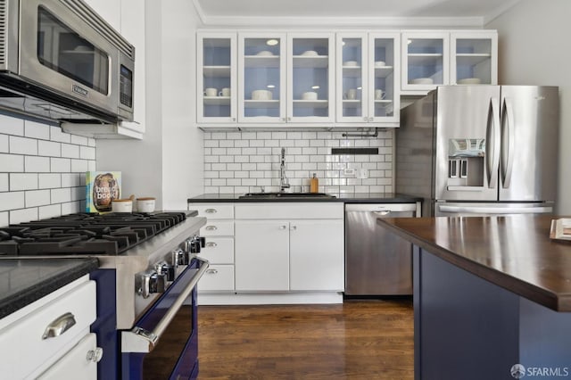 5 College Ter, San Francisco, CA 94112 - kitchen with appliances with stainless steel finishes, a sink, decorative backsplash, glass insert cabinets, and white cabinetry