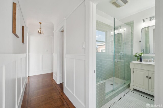 5 College Ter, San Francisco, CA 94112 - bathroom featuring a chandelier, a shower stall, vanity, a wainscoted wall, and tile patterned flooring