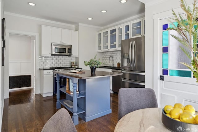 5 College Ter, San Francisco, CA 94112 - kitchen featuring appliances with stainless steel finishes, dark countertops, recessed lighting, ornamental molding, and dark wood-type flooring