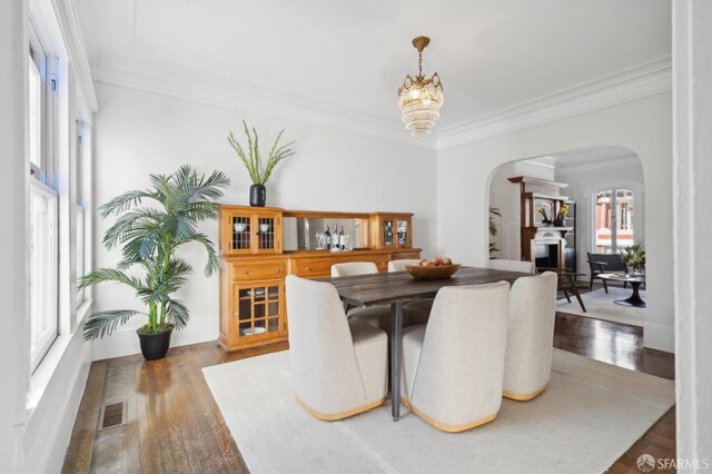 5 College Ter, San Francisco, CA 94112 - dining space featuring arched walkways, crown molding, wood finished floors, and a chandelier