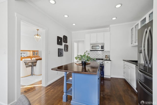 5 College Ter, San Francisco, CA 94112 - kitchen with stainless steel appliances, crown molding, white cabinetry, dark wood-style floors, and butcher block counters