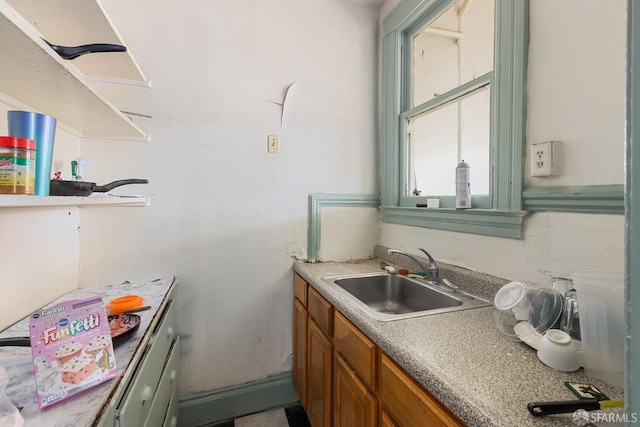 kitchen with a sink, tasteful backsplash, and brown cabinetry