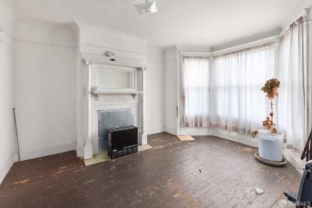 unfurnished living room with a fireplace with flush hearth and hardwood / wood-style floors