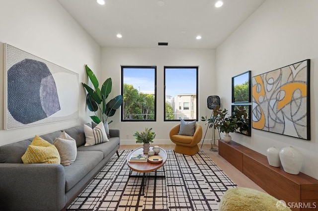 living area with baseboards and recessed lighting