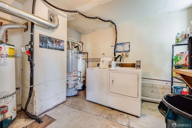 washroom with strapped water heater, separate washer and dryer, laundry area, and water heater