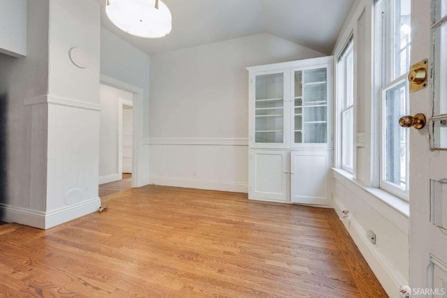 interior space featuring light wood-style floors and vaulted ceiling