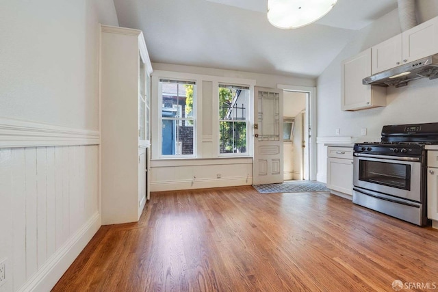kitchen featuring white cabinetry, stainless steel range with gas stovetop, light wood-type flooring, and under cabinet range hood