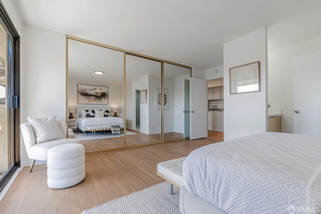 611 Stonegate Dr, South San Francisco, CA 94080 - bedroom featuring washer and dryer, wood finished floors, and a closet