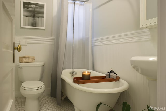 1155 Leavenworth St Unit 7, San Francisco, CA 94109 - bathroom featuring a freestanding bath, wainscoting, and a decorative wall