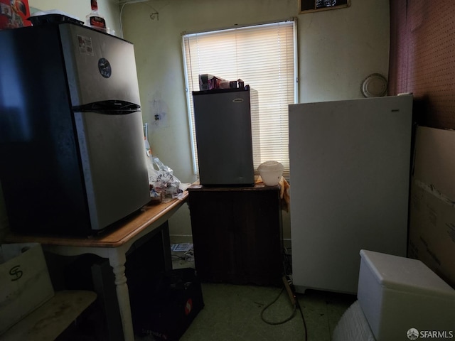 kitchen featuring water heater and stainless steel refrigerator