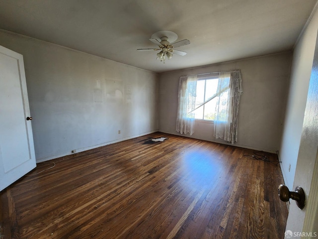 empty room featuring dark wood-type flooring and ceiling fan