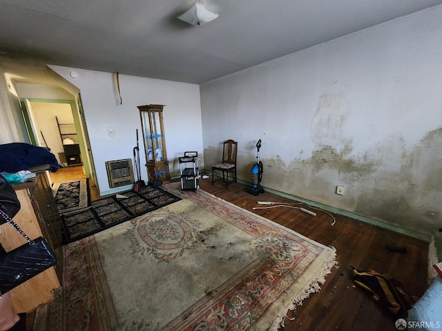 misc room featuring heating unit and hardwood / wood-style floors