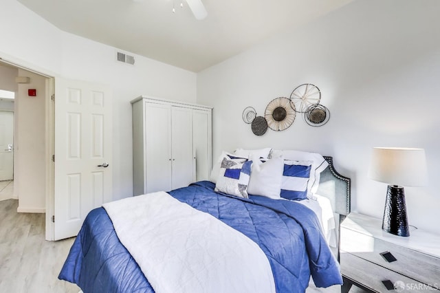 bedroom with light wood-type flooring and ceiling fan