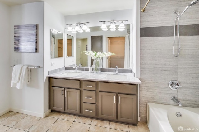 bathroom featuring tiled shower / bath combo, vanity, and tile patterned floors