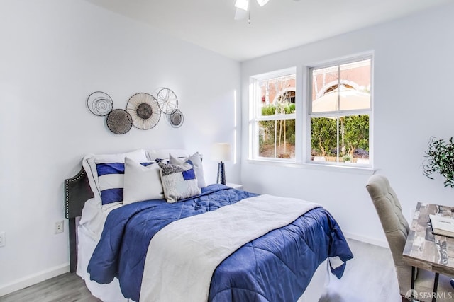 bedroom with hardwood / wood-style flooring and ceiling fan