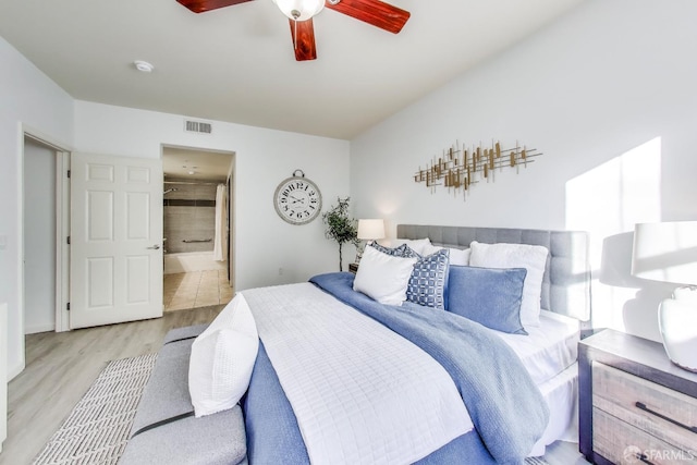 bedroom featuring ceiling fan, connected bathroom, and light wood-type flooring