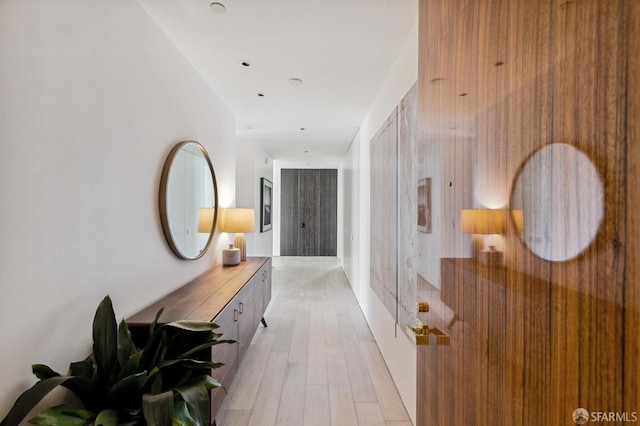 corridor with light hardwood / wood-style flooring