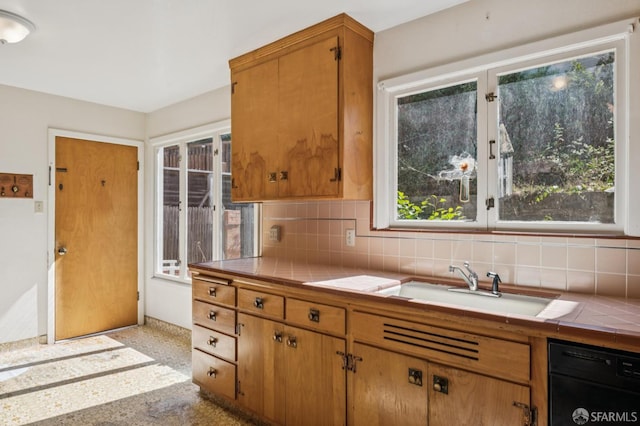 37 San Jacinto Way, San Francisco, CA 94127 - kitchen with tile counters, black dishwasher, tasteful backsplash, speckled floor, and brown cabinets