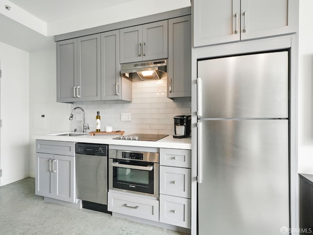 766 Harrison St Unit 711, San Francisco, CA 94107 - kitchen featuring appliances with stainless steel finishes, under cabinet range hood, gray cabinets, and light countertops