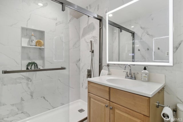 bathroom featuring toilet, a shower with door, and vanity