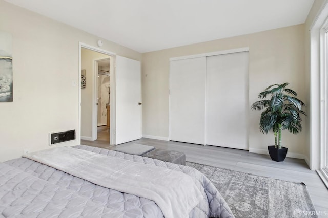 bedroom with a closet and hardwood / wood-style flooring