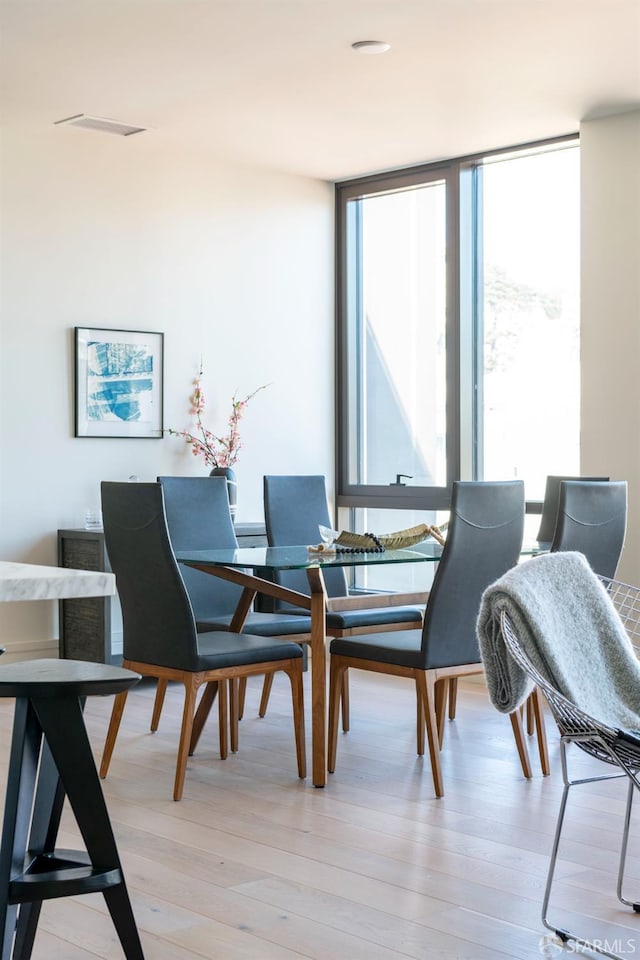 dining space featuring a wealth of natural light and light wood-style floors