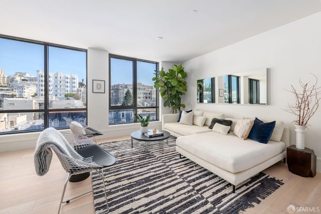 living room with a view of city and wood finished floors