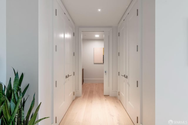 hall featuring light wood-style floors and recessed lighting