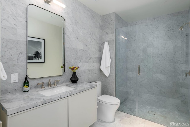 full bath featuring tile walls, a shower stall, toilet, and vanity