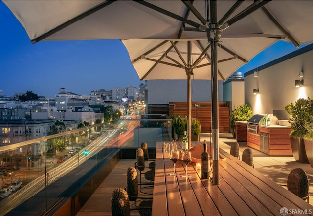 exterior space with outdoor dining area, a city view, and area for grilling