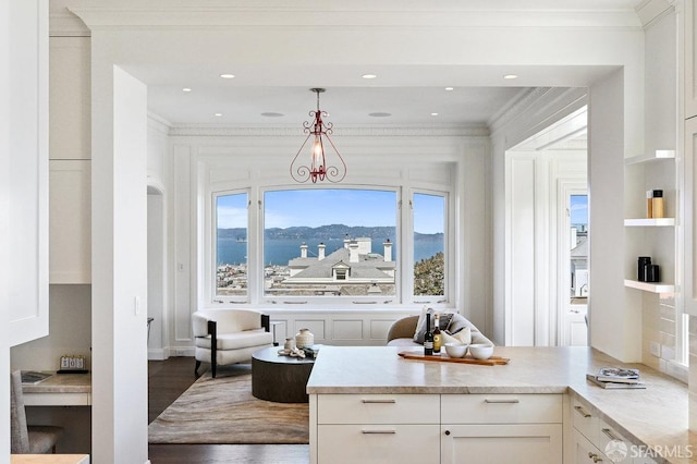 2500 Steiner St Unit 3, San Francisco, CA 94115 - kitchen featuring ornamental molding, white cabinets, light countertops, decorative light fixtures, and wood finished floors