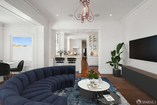 living room with dark hardwood / wood-style floors and crown molding