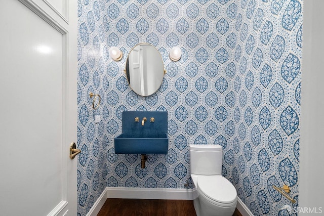 bathroom with hardwood / wood-style floors and toilet