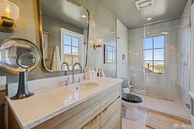 bathroom with tile patterned floors, visible vents, toilet, a stall shower, and vanity