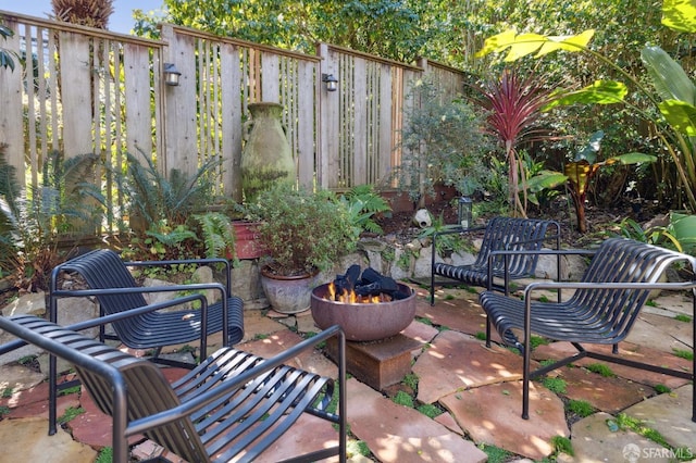 view of patio / terrace with fence and an outdoor fire pit