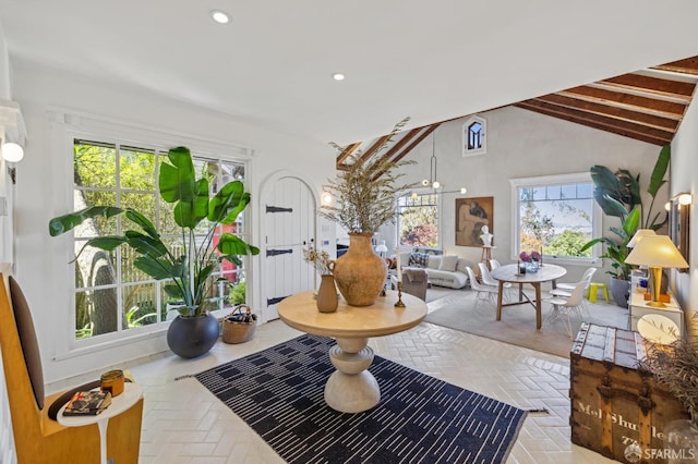 interior space featuring recessed lighting, high vaulted ceiling, and brick floor