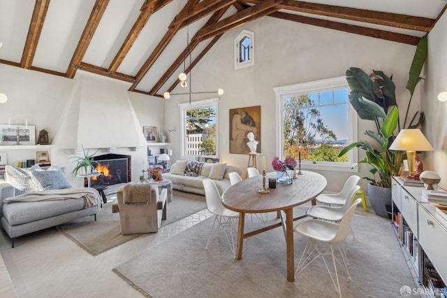 living area featuring high vaulted ceiling, beamed ceiling, a wealth of natural light, and a large fireplace