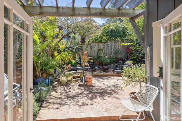 view of patio / terrace with a pergola and fence