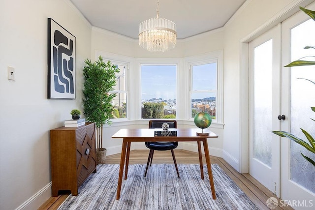 office area with a notable chandelier, wood finished floors, and ornamental molding