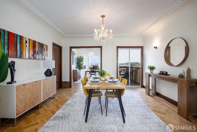 dining area featuring an inviting chandelier, crown molding, baseboards, and a textured ceiling