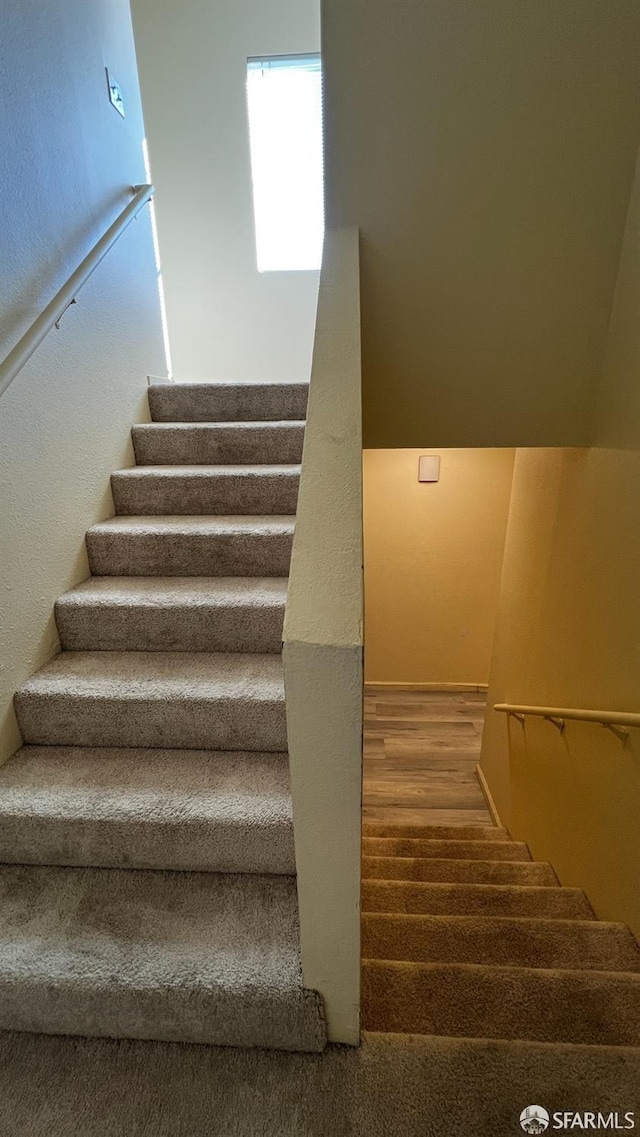 staircase featuring wood finished floors